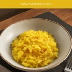 Creamy saffron risotto with visible saffron threads served in a bowl.