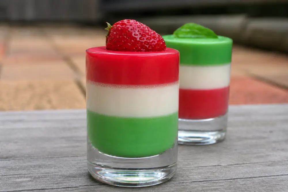 Italian layered panna cotta with strawberry and mint toppings.