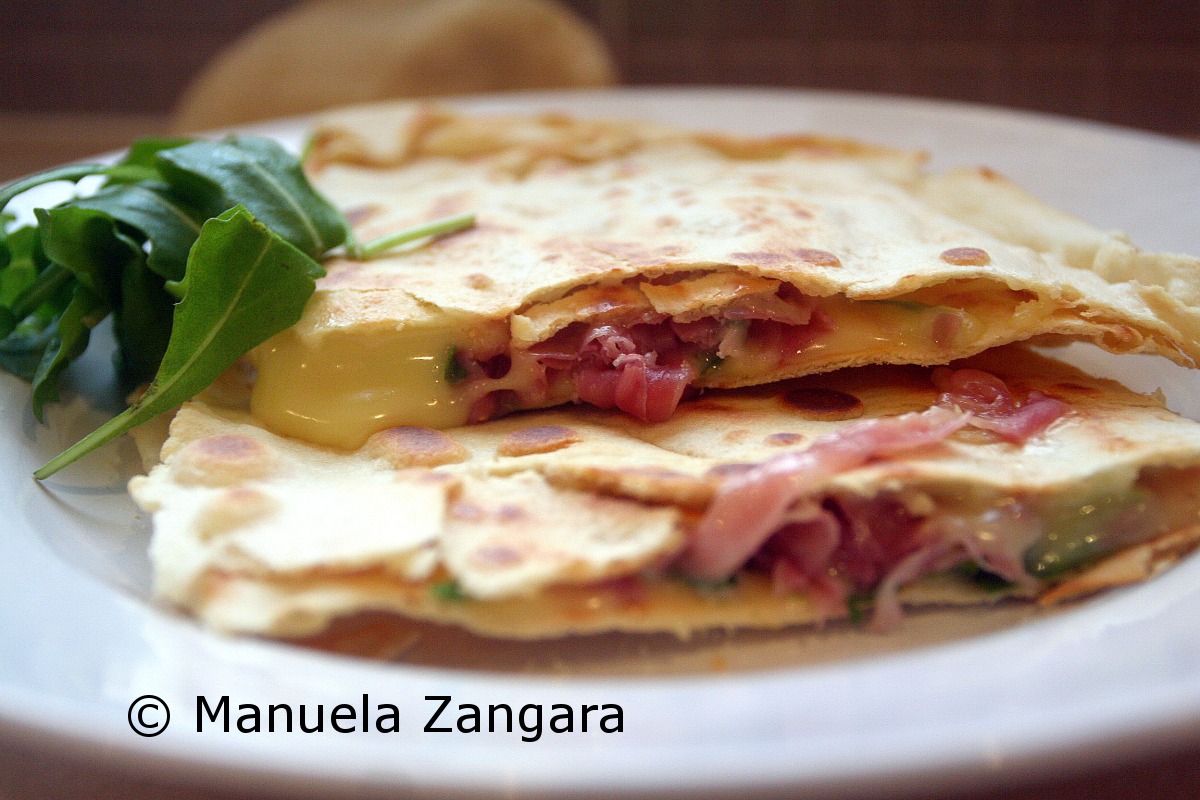 Homemade Piadina with prosciutto, stracchino and rocket