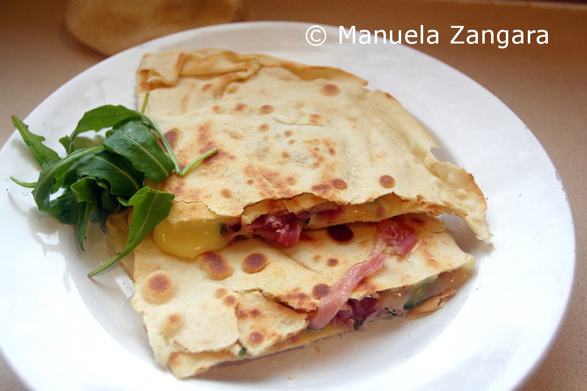 Homemade Piadina with prosciutto, stracchino and rocket