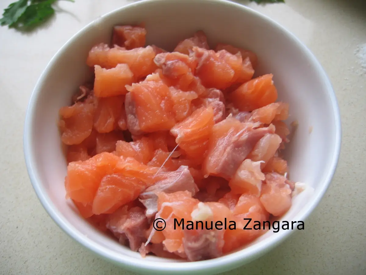 Finely chopped raw salmon in a bowl.