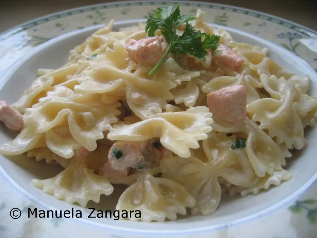 Creamy farfalle with salmon served on a plate.