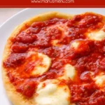 Fried pizza topped with tomato sauce and melted mozzarella on a golden base.
