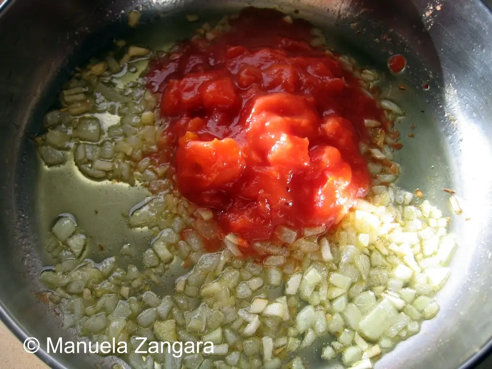 Onions and garlic softened in olive oil with tomatoes added to the centre.