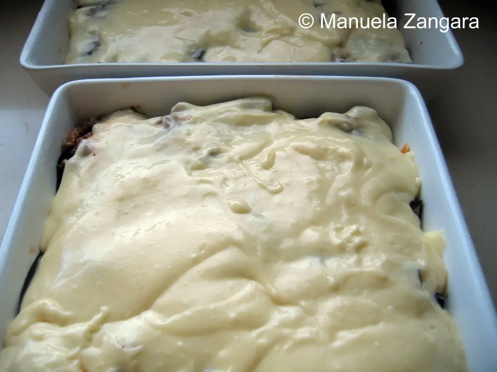 IMG_1184 Cheese sauce spread over the assembled moussaka in a baking dish.