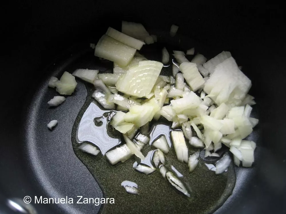 Chopped onions sautéing in olive oil.