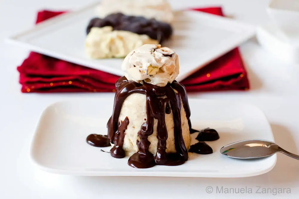 Semifreddo al Torroncino with hot chocolate sauce on a plate.