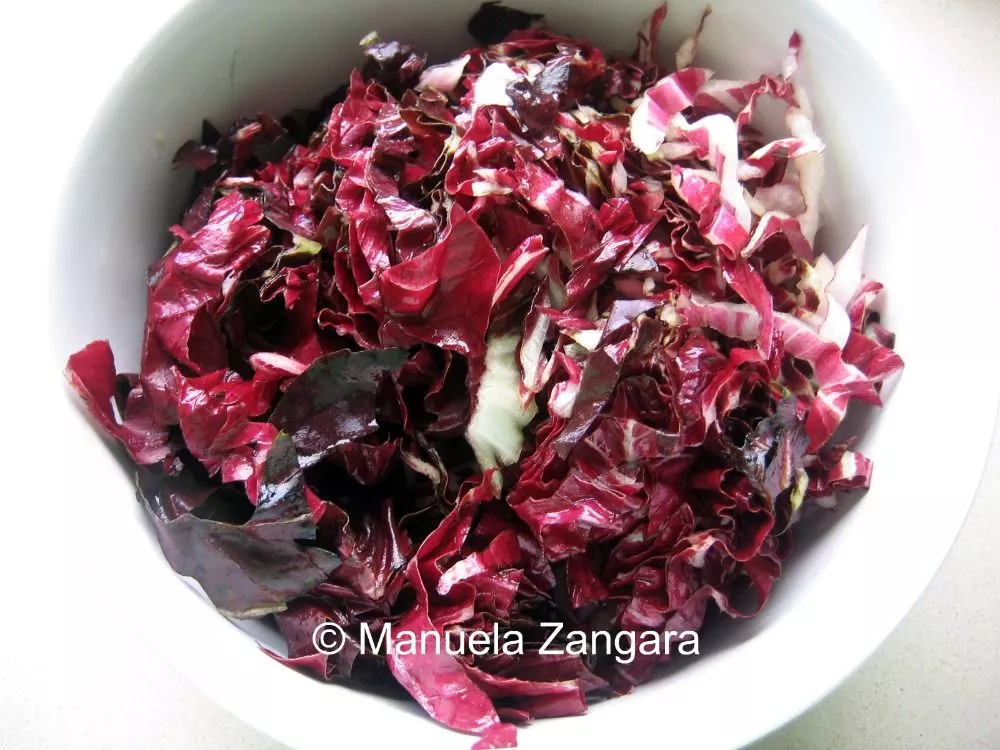 Freshly shredded radicchio in a white bowl.