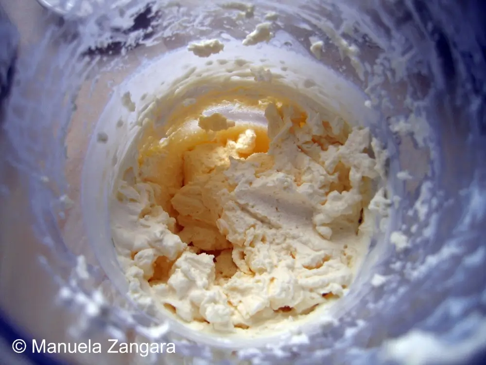 Whipped cream beaten to soft peaks in mixing bowl.