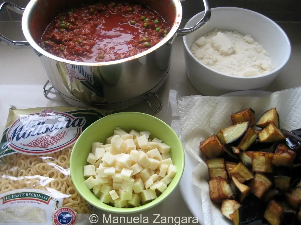 Prepped ingredients for baked anelletti arranged on the counter.