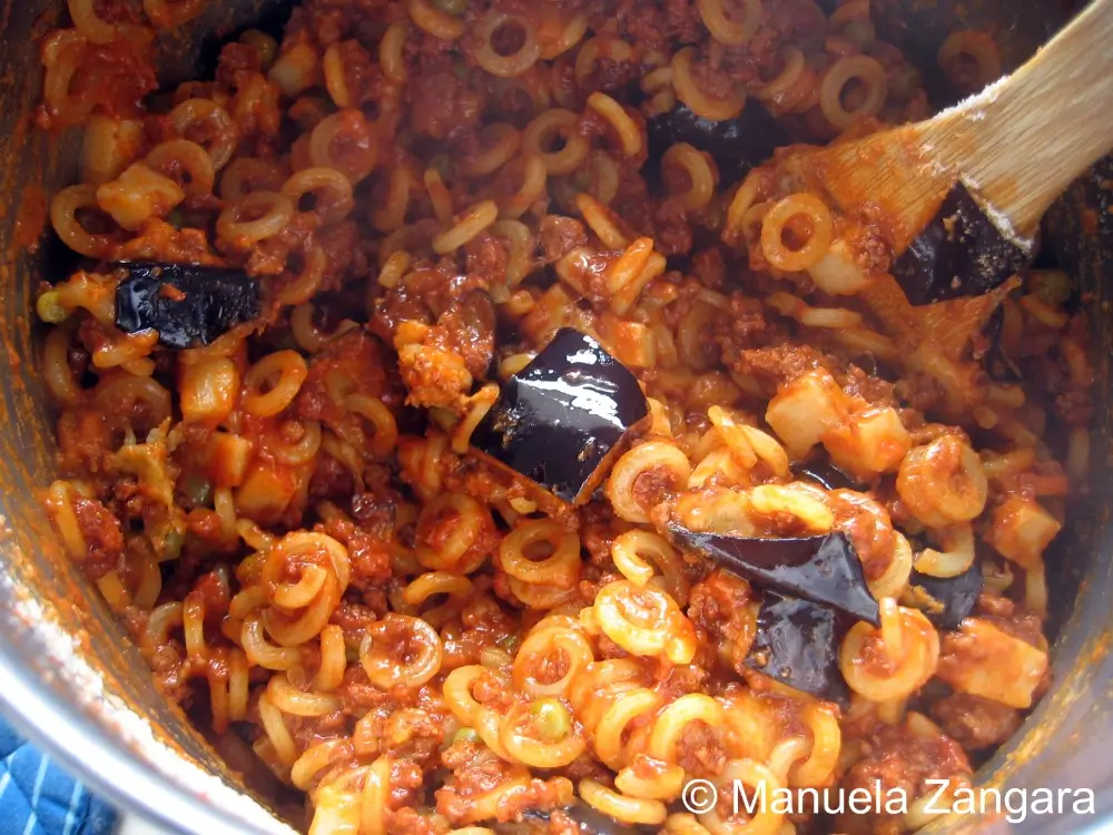 Anelletti mixed with ragù, eggplant, and cheese.