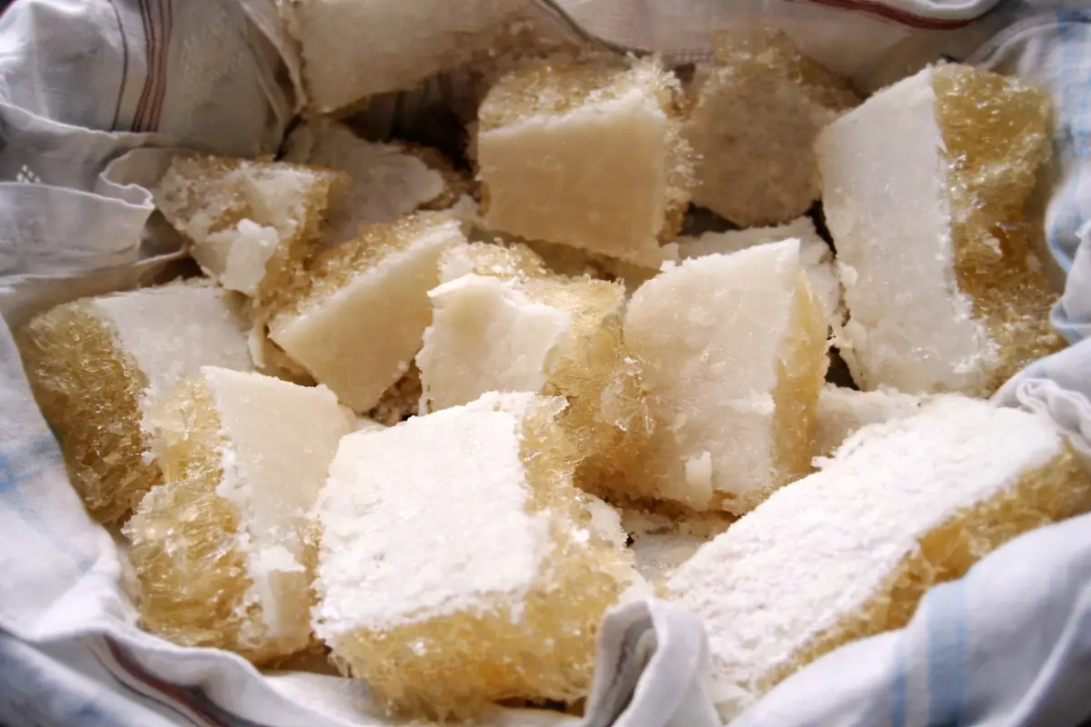 Frozen stock cut into chunks and placed in cloth for filtration.