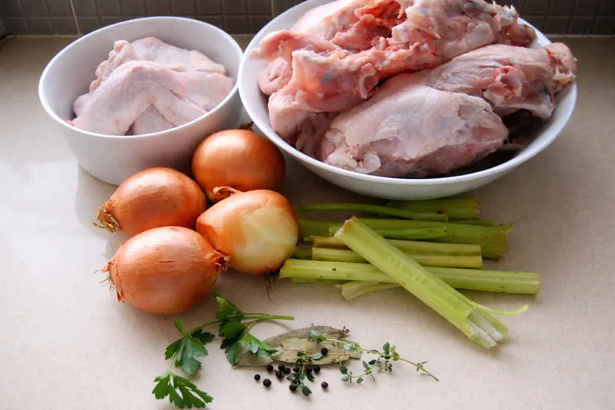 Chicken bones and wings with onions, celery, and herbs for stock.