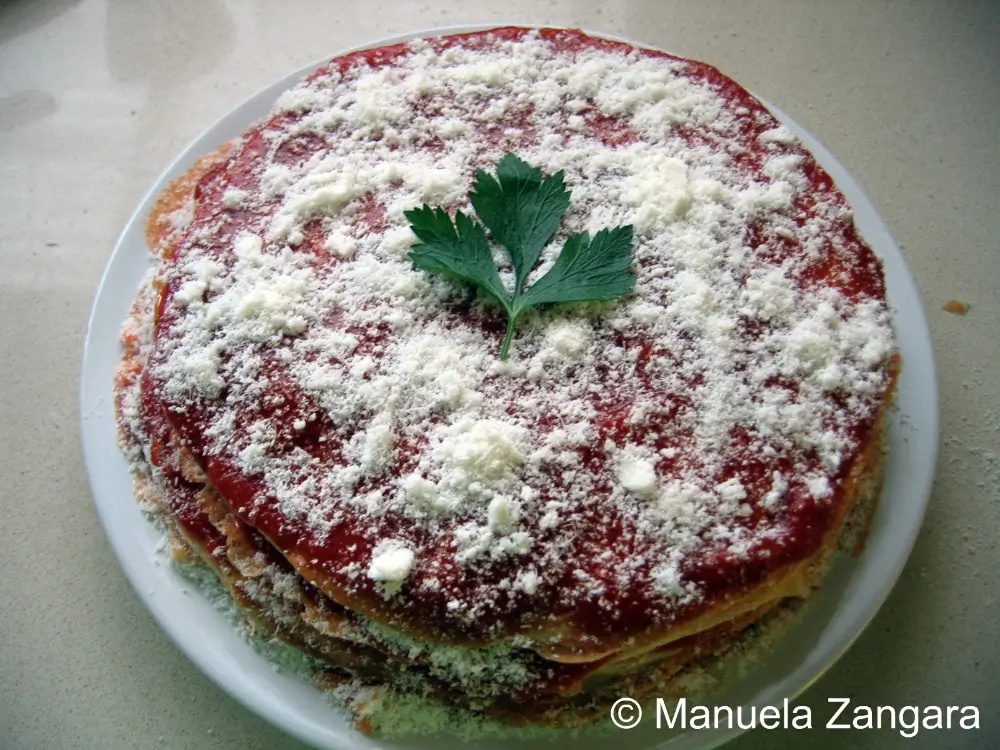 Layered frittatine finished with tomato sauce and a generous sprinkle of Parmigiano Reggiano.
