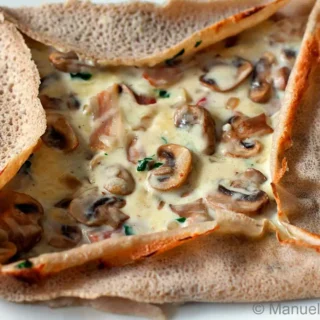 Close-up of the finished Galette Bretonne à la Forestière showing its crisp edges and creamy centre.