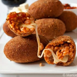 Crispy fried Italian rice balls filled with melted mozzarella.