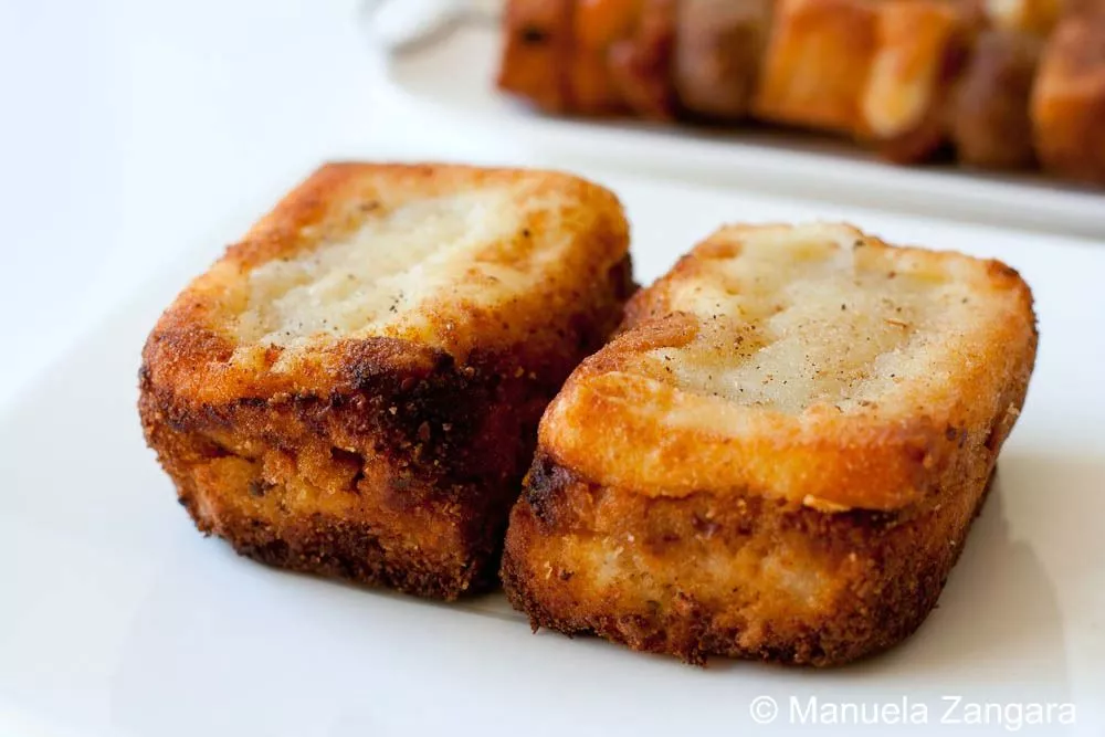 Crostini Close-up of crispy crostini filled with rich meat sauce and melted cheese.