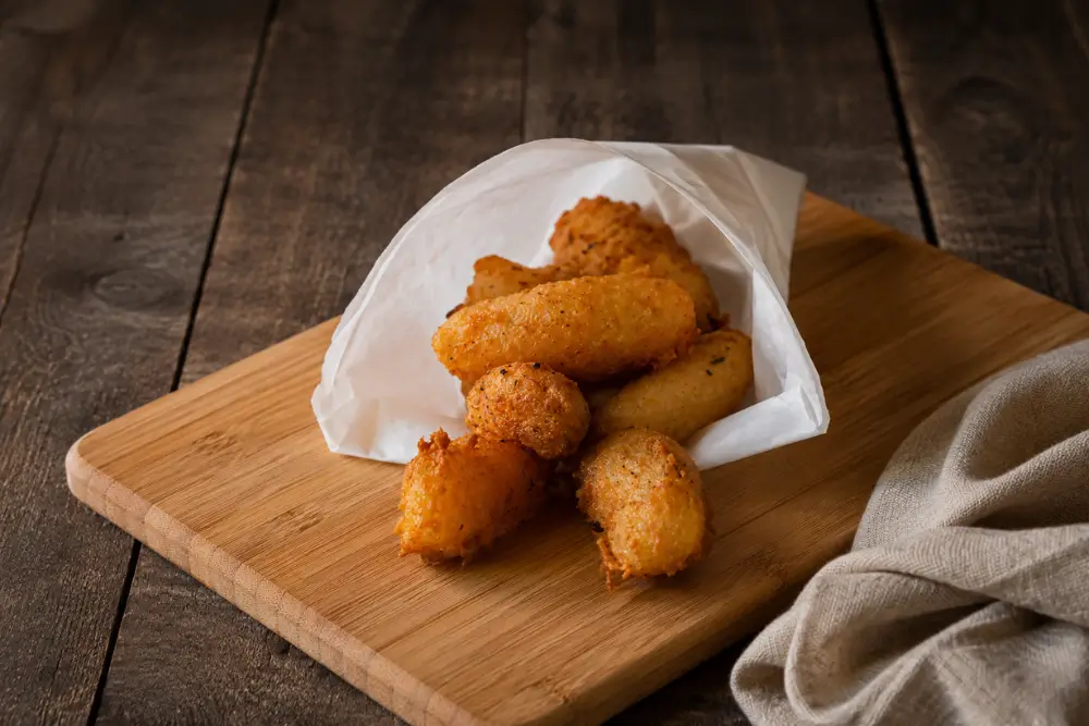 Fried potato croquettes with crisp golden-brown crusts served fresh and hot.