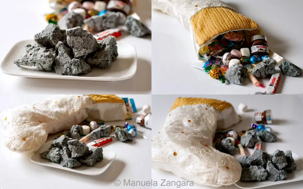 Italian sweet coal candy served on a plate and tucked inside festive stockings with sweets.