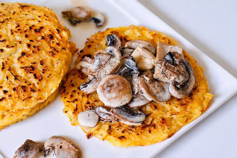 Creamy mushroom ragout spooned over a golden crispy rösti.