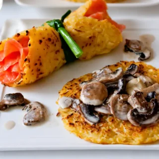 Potato rösti served with creamy mushroom ragout alongside a smoked salmon rösti wrap.
