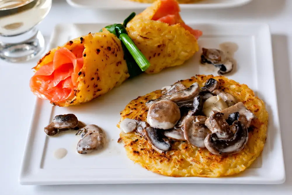 Potato rösti served with creamy mushroom ragout alongside a smoked salmon rösti wrap.