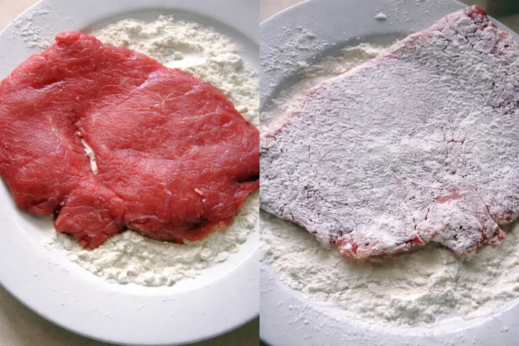 Veal being placed on flour and then evenly coated before cooking.