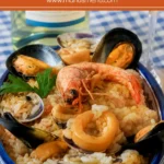 Risotto alla Marinara served in a blue bowl with prawns, mussels, clams, calamari, and white wine beside the plate.