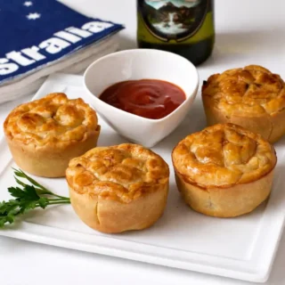 Mini meat pies served warm with ketchup on the side.