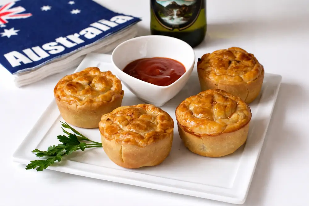Mini meat pies served warm with ketchup on the side.