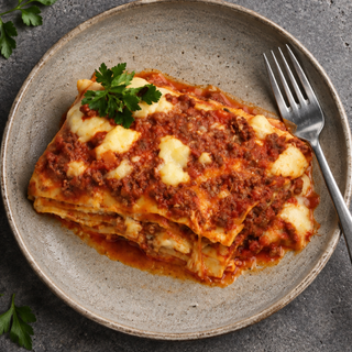 Close-up of Baked Lasagne with layers of pasta, meat sauce and melted cheese.
