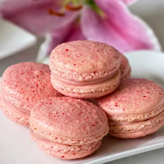 Filled Raspberry White Chocolate Macarons showing raspberry macarons with creamy ganache.