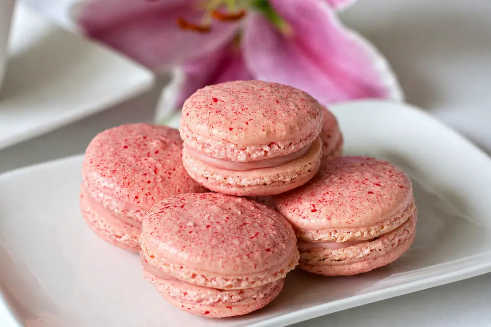 Raspberry and White Chocolate Macarons Filled Raspberry White Chocolate Macarons showing raspberry macarons with creamy ganache.