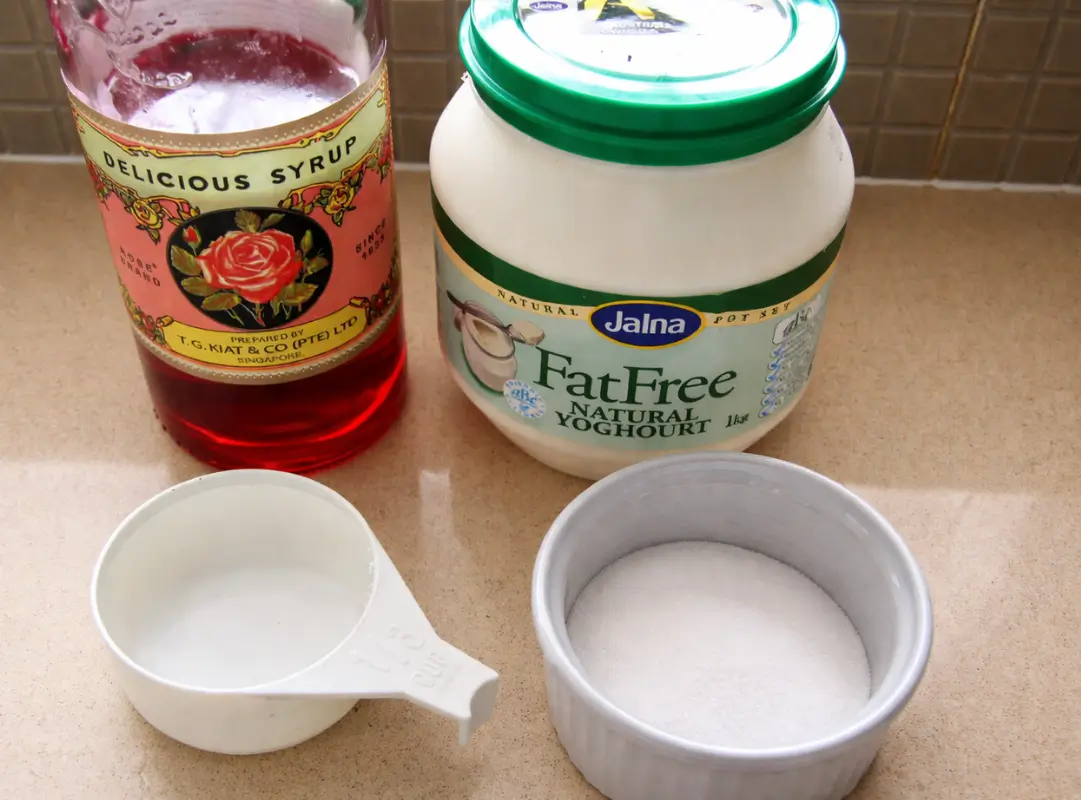 Ingredients for rose lassi on a kitchen counter.