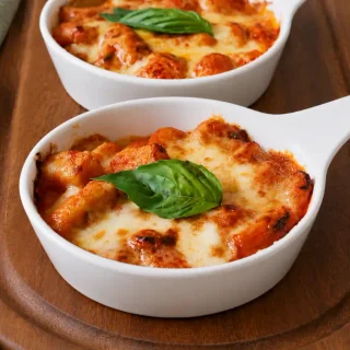 Gnocchi alla Sorrentina topped with melted mozzarella and fresh basil.