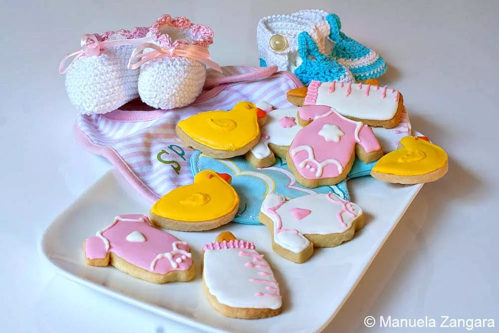Baby Shower Shortbread Cookies Baby Shower Shortbread Cookies decorated with pink onesies, yellow duck, and white baby bottle cookies.