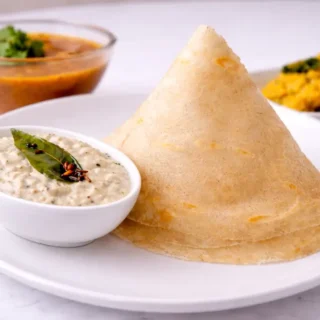 Paper thin dosa served with coconut chutney.