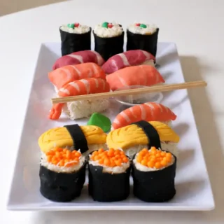 Assembled sweet sushi pieces arranged on a serving plate.