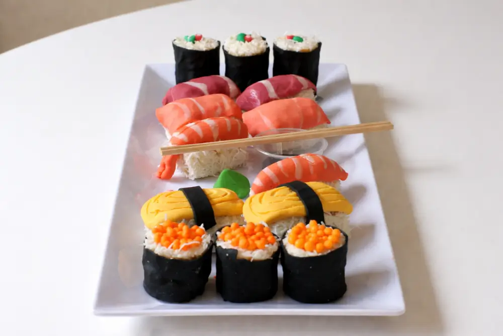 Assembled sweet sushi pieces arranged on a serving plate.