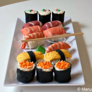 Assembled sweet sushi pieces arranged on a serving plate.