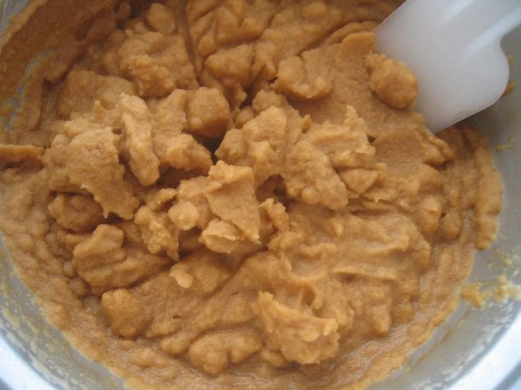 Coffee granita mixture forming light crystals during the freezing process.