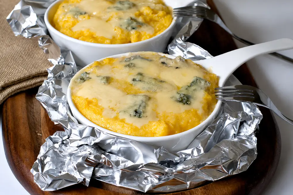 Polenta Concia layered with melted Gorgonzola, Fontina, and Parmigiano Reggiano.