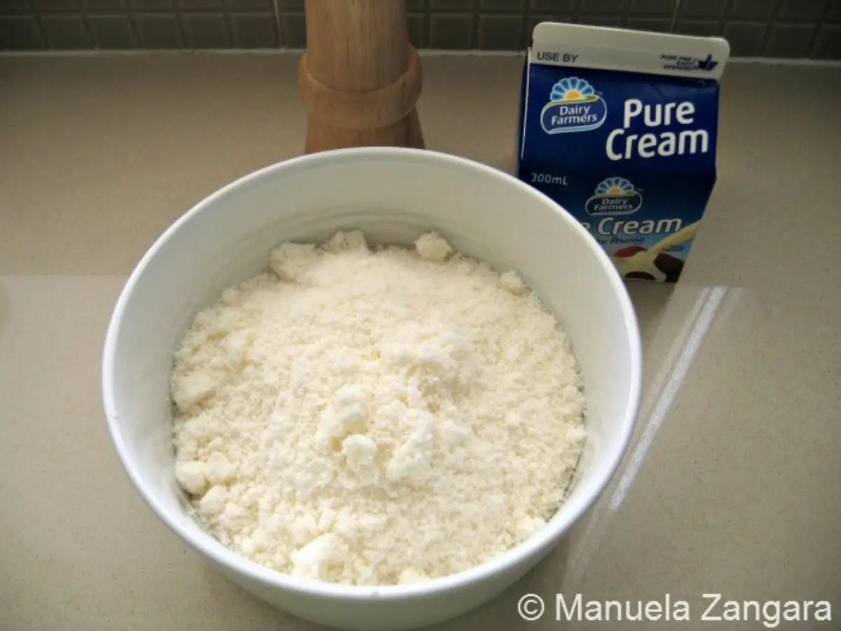 Finely grated hard cheese in a bowl.