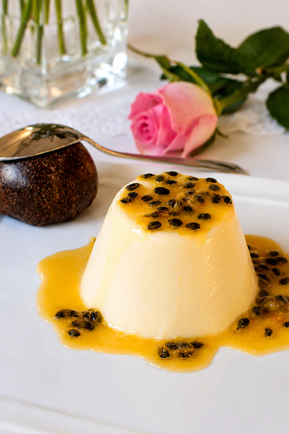 Passion Fruit Panna Cotta with Vanilla Cream topped with glossy passion fruit coulis and fresh passion fruit seeds.