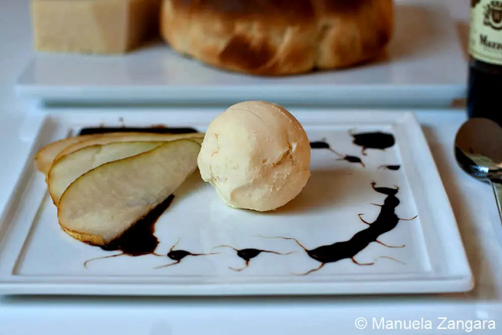 Scoop of savoury gelato plated as an appetiser with pear.