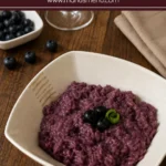 Creamy purple risotto topped with fresh blueberries and green onion.