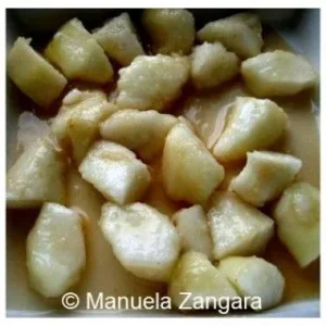 Cubes of pears baked with maple syrup until soft and caramelised in a baking dish.