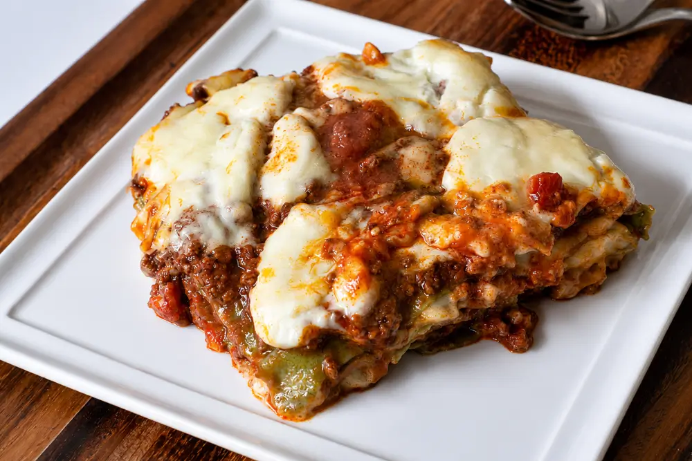 Warm baked lasagne served with creamy melted cheese and rich meat sauce.