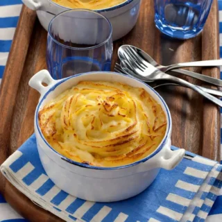 Golden mashed potato topping with a crisp surface over a rich minced lamb filling.
