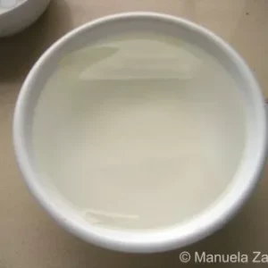 Bowl with gelatine sheets soaking in cold water.